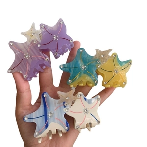 Starfish shaped acetate hair claw clips with rhinestones in assorted pastel colors