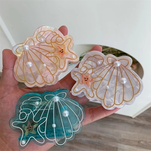 Three-piece ocean themed hair clips with starfish, shell designs and pearl accents