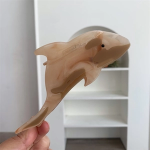 Detail of marble pattern acetate hair claw clip in whale shape for thick hair