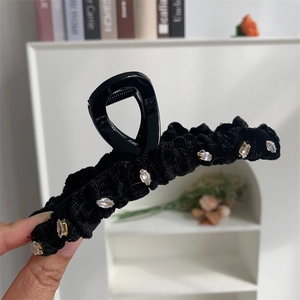 Détails de la pince à cheveux en velours noir ornée de strass et ressort métallique