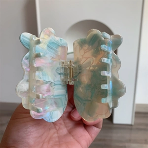 Detail shot of ocean series acetate hair claw clip with colorful marble pattern