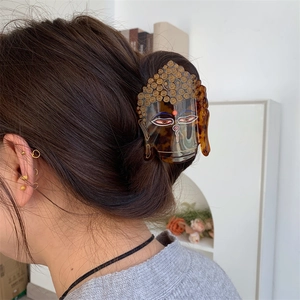 Pince à cheveux unique en acétate écaille de tortue avec design de tête de bouddha