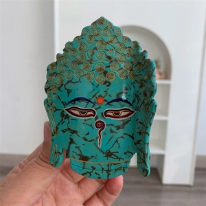 Pince à cheveux en acétate turquoise avec un design détaillé de tête de Bouddha