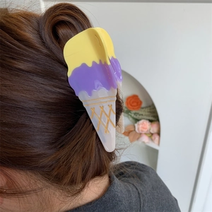 Side view of a creative ice cream shaped hair claw clip worn on hair with waffle patterns