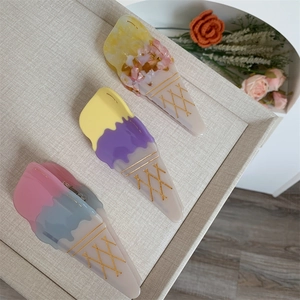 Detailed view of acetate shark hair claws with creative ice cream cone shape design