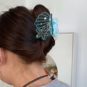 Deep green shell-shaped acetate hair claw clip with star fish patterns and pearls