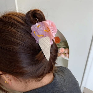 Detailed back view of a pink ice cream cone hair claw clip styled on wavy hair