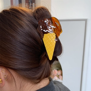 Detailed hair claw clip shaped like a chocolate ice cream cone with yellow waffle pattern