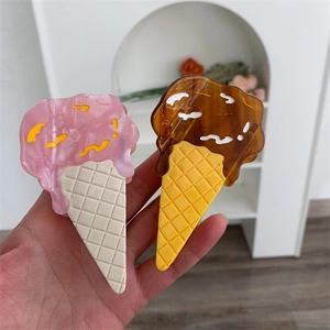 Detail of creative ice cream hair claws featuring chocolate and cream melting textures