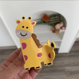 Close-up of giraffe hair claw clip with colorful acetate finish and smooth texture