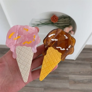 Detail of sweet ice cream style acetate hair claw clips in pink and chocolate colors