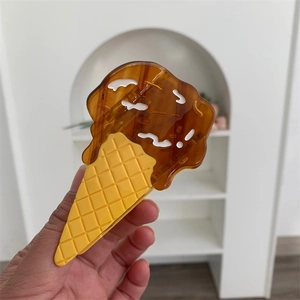 Detailed view of 3D ice cream cone hair claw clip with chocolate and waffle texture