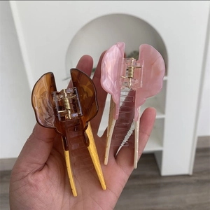 Detail of sweet ice cream cone shaped hair claw clips in brown and pink acrylic