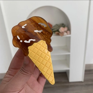 Detail of ice cream shaped acetate hair claw clip with chocolate and cone pattern