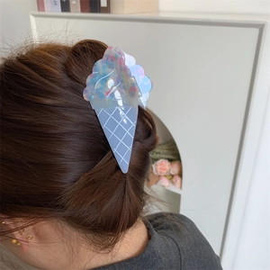 Detail showing ice cream cone hair claw clip with colorful texture in hair