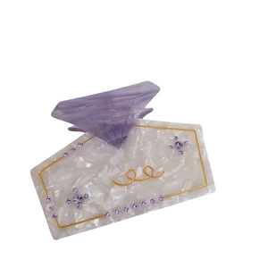 Elegant white acetate shark hair claw clip with purple rhinestones and gold wavy wire patterns