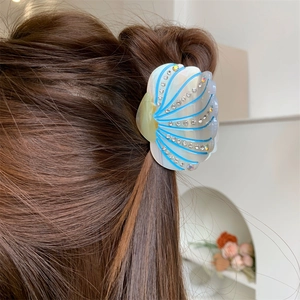 Elegant shell-shaped acetate hair claw with rhinestones in pearl blue and white