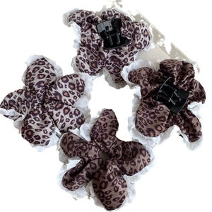 Leopard print hair accessory set with white lace trim featuring clips and a scrunchie
