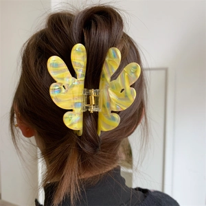 Detailed back view of a marbled yellow acetate butterfly hair claw clip for women