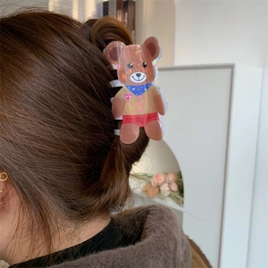 Sweet brown bear hair claw clip with colorful details worn on long brunette hair