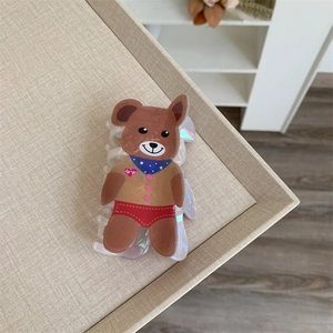 Detailed view of brown cartoon bear hair claw clip in iridescent acetate material