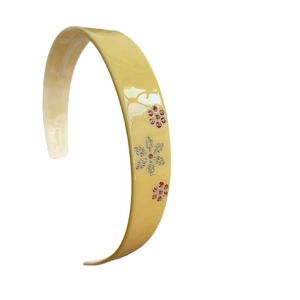 Cerchietto dolce in acetato giallo con delicati fiori di strass e finitura lucida