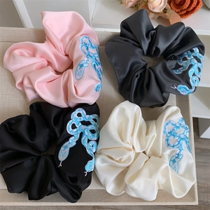 Satin scrunchies set with snake embroidery in pink, black, and beige colors