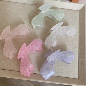 Set of floral acrylic claw clips in pastel colors with glitter finish for long hair