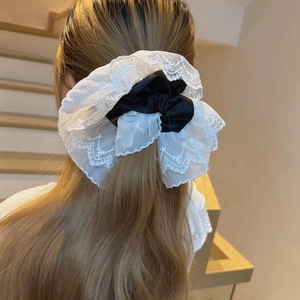French oversized double-layered lace scrunchie with floral embroidery on hair ponytail