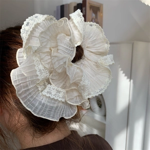 Lace ruffled oversized hair scrunchie in creamy white worn on a ponytail back view