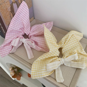 Close-up of pink and yellow plaid cotton hair scrunchie with elegant lace trim edge