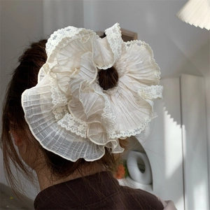 Detailed back view of oversized cream lace scrunchie with pleated chiffon textures