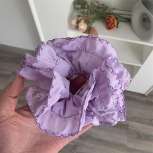 Elegant purple ruffled scrunchie with wavy edges for a minimalist girls hair accessory