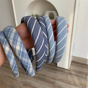 Detailed view of thick plaid and striped padded headbands in fresh blue tones