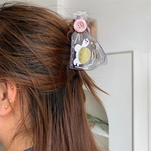 Transparent tortoiseshell hair claw with cute turtle print and pink button detail
