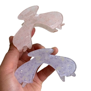 Pair of floral acrylic claw clips in glittery pink and purple for long hair styling