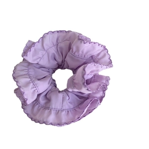 Elegant purple ruffled scrunchie with layered fabric edges for women hairstyles