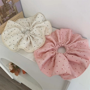 Elegant large polka dot satin scrunchies in pink and beige with jacquard fabric texture