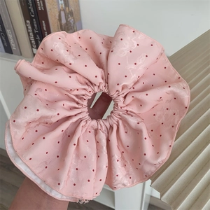 Detail of pink polka dot scrunchie with floral jacquard texture and high elastic band