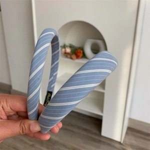 Detailed close-up of sky blue plaid padded headband with soft sponge texture