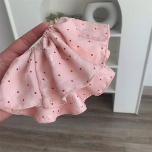 Detailed texture of pink polka dot hair scrunchie with jacquard woven fabric