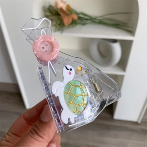 Minimalist transparent acetate hair claw clip featuring a cute cartoon turtle and pink button