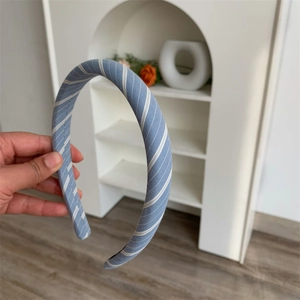 Detail of light blue checkered headband with premium soft fabric and smooth stitching