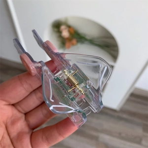 Close-up of a unique transparent acetate hair claw clip with a green PCB circuit board insert