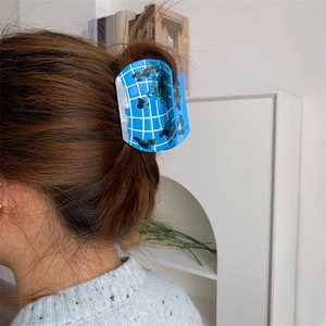 Blue acetate hair claw clip with geometric globe map pattern for women's hairstyle