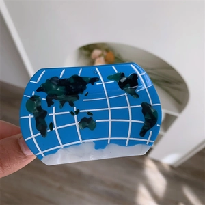 Artistic blue acetate hair claw clip featuring a world map globe pattern and glossy finish