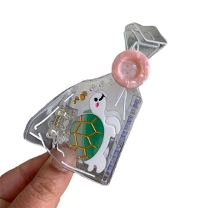 Creative transparent acetic hair claw with a cute green turtle and pink button detail