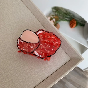 Macro shot of a creative lychee hair claw clip with realistic texture and translucent resin