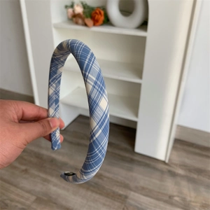 Detail of blue and white checkered pattern fabric on a slim minimalist headband