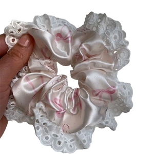 Sweet beige satin scrunchie with pink bow patterns and elegant white lace trim edge